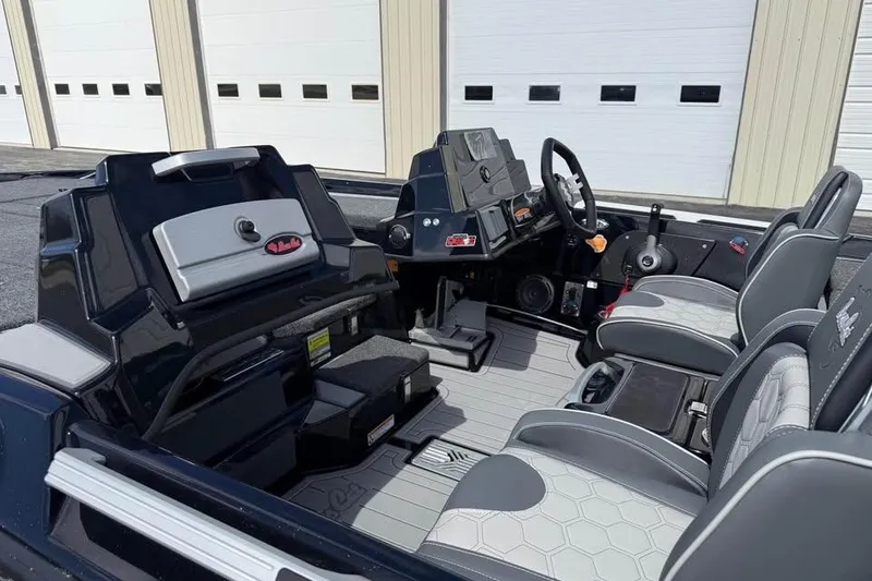 Slide: The Image of 2026 Bass Cat Jaguar STS boat interior with modern seating and control panel. - 9