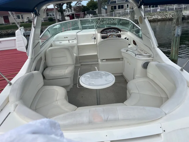 Slide: The Image of Interior of a 2021 Sea Ray 280 Sun Sport with white leather seating. - 10
