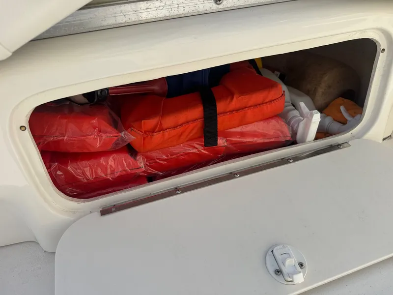 Slide: The Image of Sea Ray 280 Sun Sport storage with life jackets, 2021 model. - 16