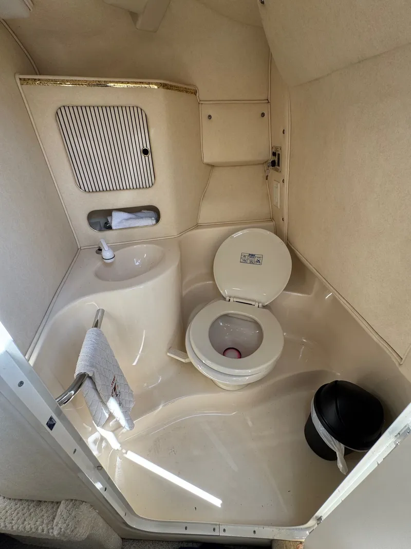 Slide: The Image of Interior of 2021 Sea Ray 280 Sun Sport with toilet and sink. - 22
