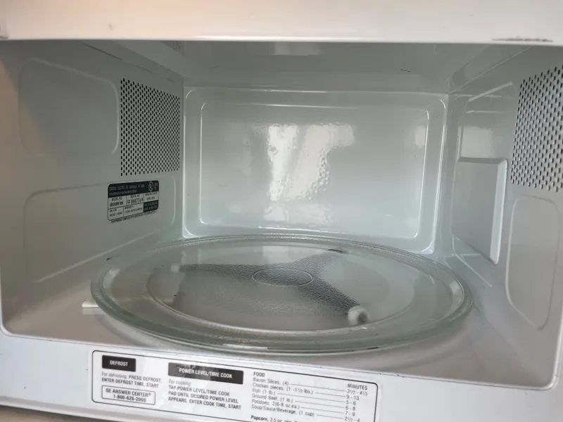 Slide: The Image of Interior view of a microwave with a turntable. - 29