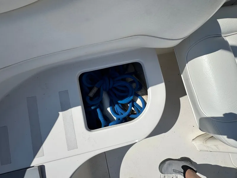 Slide: The Image of Storage compartment in 2021 Sea Ray 280 Sun Sport with blue ropes. - 48
