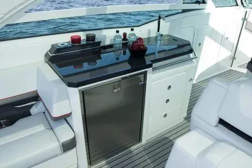 Slide: The Image of 2019 Formula 430 Super Sport Crossover yacht interior with sleek kitchenette and seating. - 12