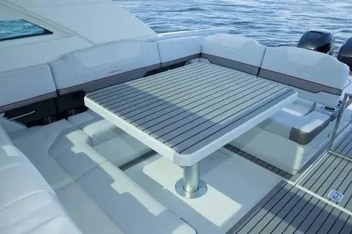 Slide: The Image of 2019 Formula 430 Super Sport Crossover yacht with sleek deck seating and table. - 14