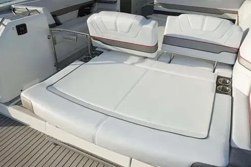 Slide: The Image of 2019 Formula 430 Super Sport Crossover boat interior with white seating and cup holders. - 16