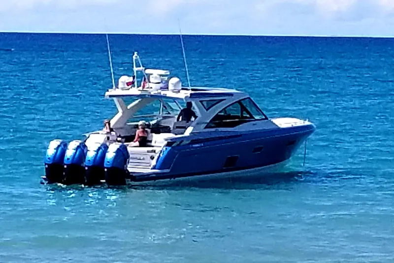 Slide: The Image of 2019 Formula 430 Super Sport Crossover boat cruising on clear blue ocean waters. - 2