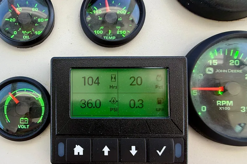 Slide: The Image of Dashboard of a 1980 Roughwater 41 boat with various gauges and digital display. - 10