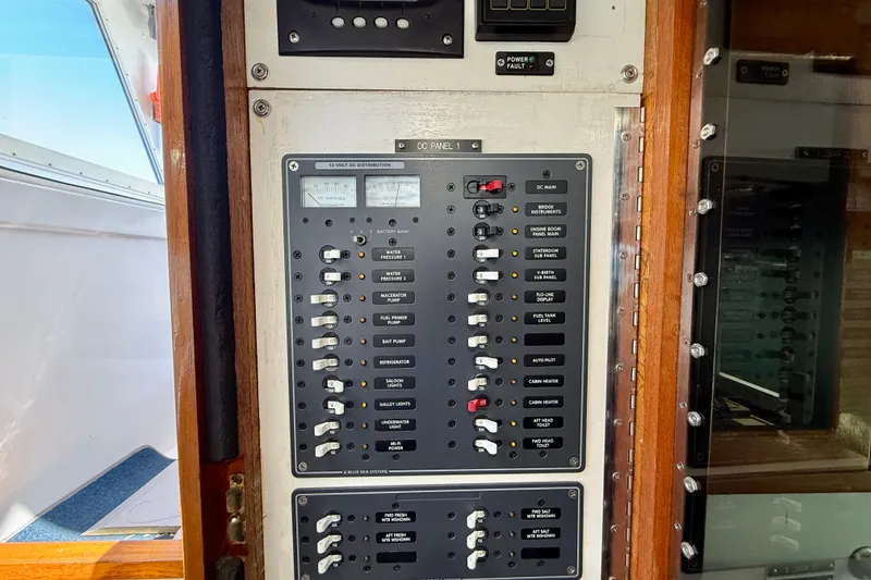 Slide: The Image of Electrical control panel on a 1980 Roughwater 41 boat, featuring various switches and gauges. - 17