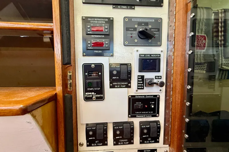 Slide: The Image of Control panel of a 1980 Roughwater 41 boat with various switches and indicators. - 18