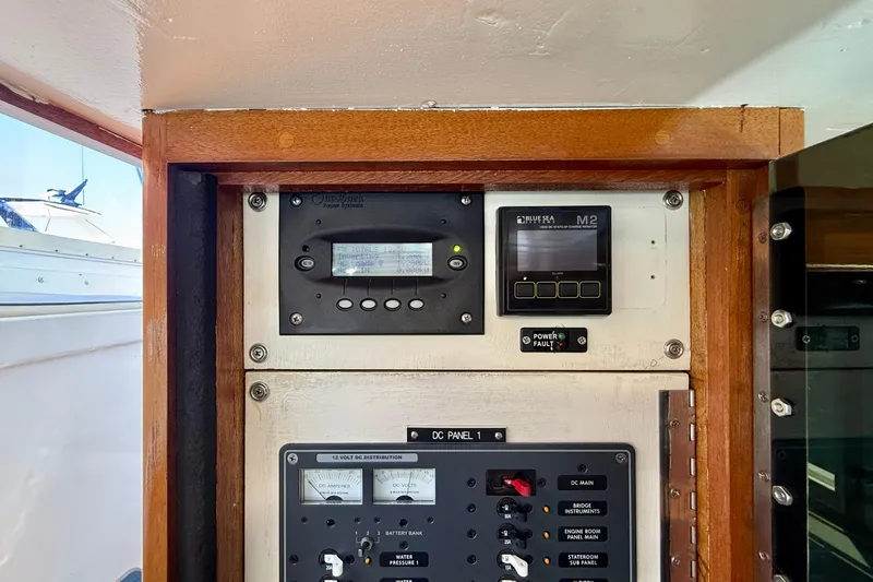 Slide: The Image of Electrical control panel on a 1980 Roughwater 41 boat, featuring various gauges and switches. - 19