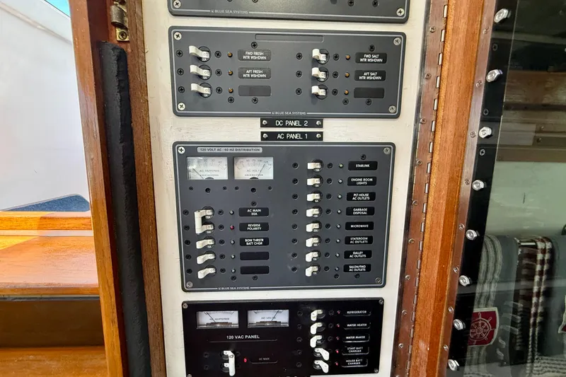 Slide: The Image of Electrical control panel on a 1980 Roughwater 41 boat, featuring various switches and meters. - 20