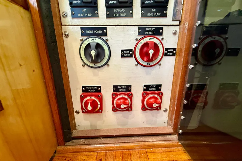Slide: The Image of Control panel of a 1980 Roughwater 41 boat with power switches and labels. - 21