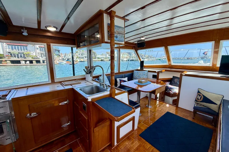 Slide: The Image of Interior of 1980 Roughwater 41 boat with wooden finishes and waterfront view. - 24