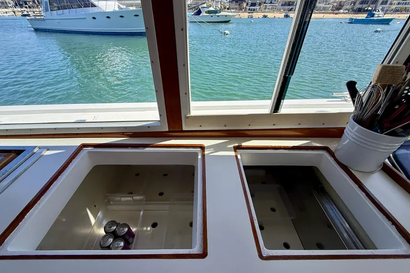 Slide: The Image of Interior view of 1980 Roughwater 41 boat with open compartments and ocean backdrop. - 27