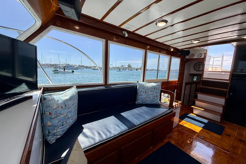 Slide: The Image of Interior of 1980 Roughwater 41 yacht with scenic marina view through large windows. - 33