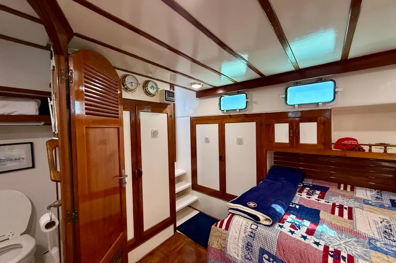Slide: The Image of Interior of 1980 Roughwater 41 boat cabin with wooden finishes and nautical decor. - 43