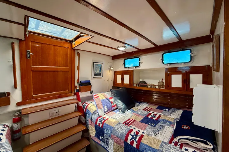 Slide: The Image of Cozy cabin interior of 1980 Roughwater 41 boat with nautical decor and wooden finishes. - 45