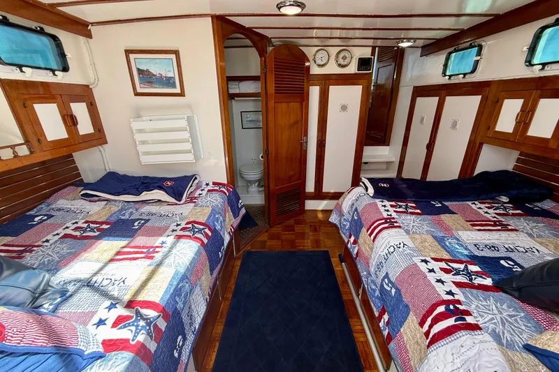 Slide: The Image of Interior of 1980 Roughwater 41 boat with twin beds and nautical decor. - 46