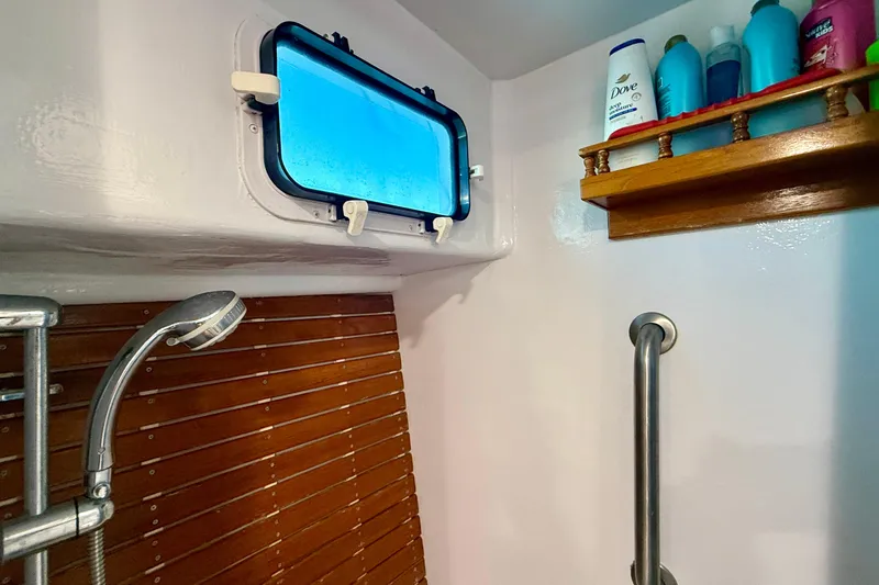Slide: The Image of Shower area in 1980 Roughwater 41 boat with wooden accents and toiletries shelf. - 49