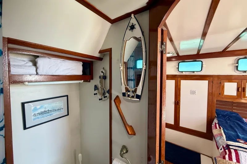 Slide: The Image of Interior of 1980 Roughwater 41 boat with nautical decor and wooden accents. - 50