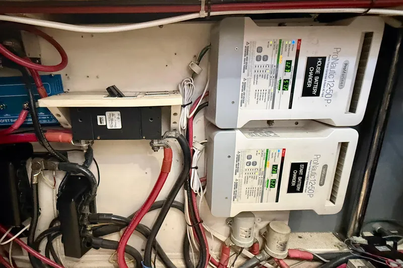 Slide: The Image of Electrical system of a 1980 Roughwater 41 boat with battery chargers and wiring. - 63