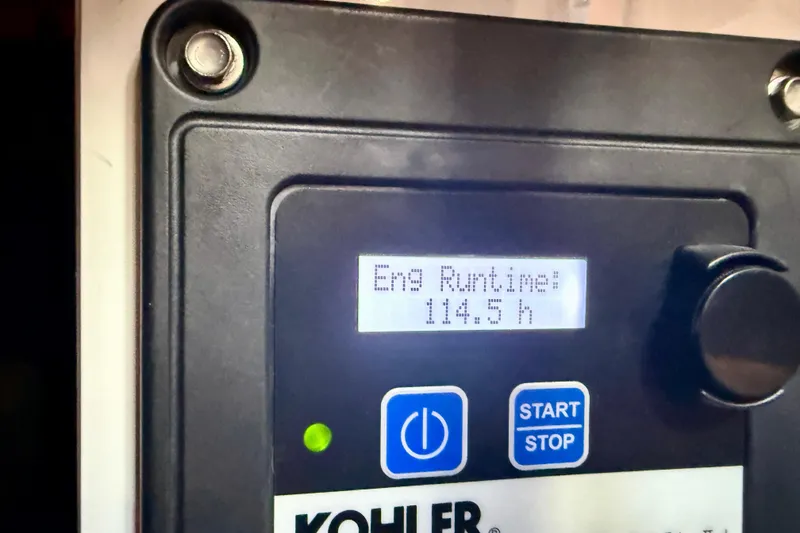 Slide: The Image of Kohler engine control panel displaying runtime of 114.5 hours on Roughwater 41, 1980 model. - 64