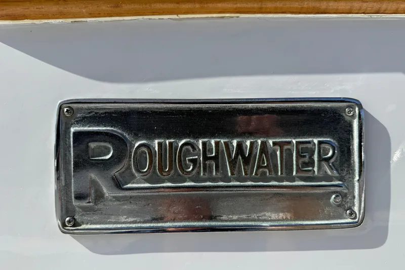 Slide: The Image of Metallic "Roughwater" nameplate on a 1980 Roughwater 41 boat. - 65