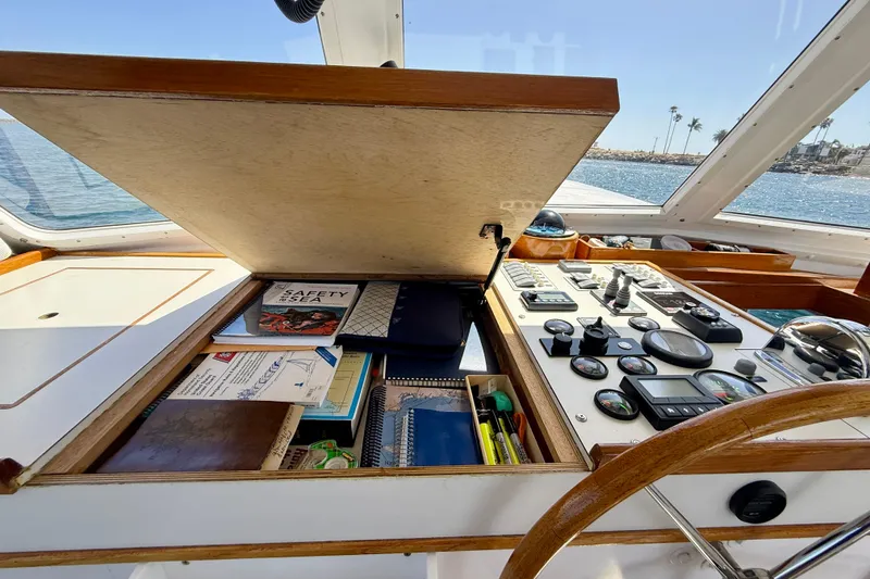 Slide: The Image of 1980 Roughwater 41 boat cockpit with navigation tools and control panel. - 8