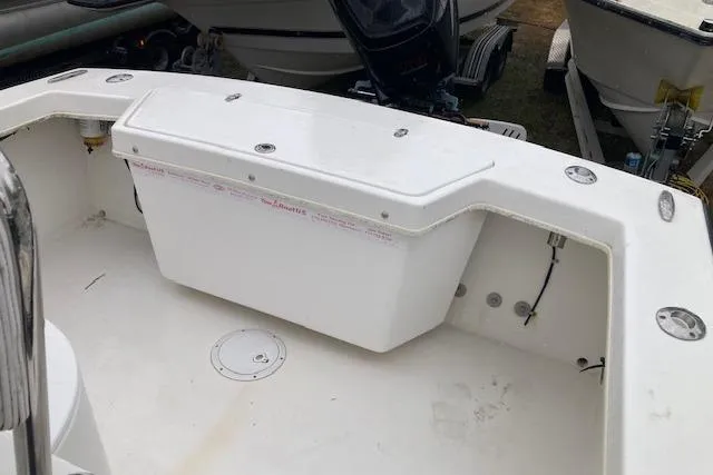 Slide: The Image of 2009 Judge 27 Center Console boat interior with storage compartment and outboard motor. - 10