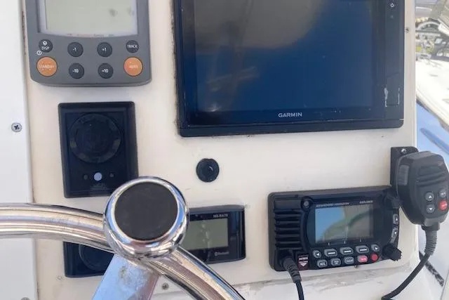 Slide: The Image of 2009 Judge 27 Center Console boat dashboard with Garmin navigation and communication equipment. - 7
