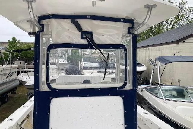Slide: The Image of 2009 Judge 27 Center Console boat with windshield wiper, docked among other boats. - 9