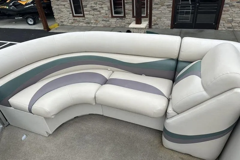 Slide: The Image of 2011 South Bay 420 CR boat seating with white, gray, and green upholstery. - 12