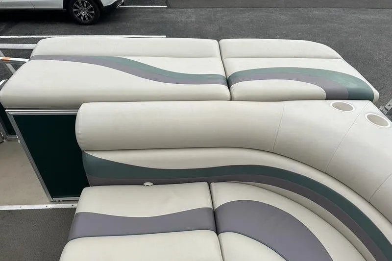 Slide: The Image of 2011 South Bay 420 CR boat interior with cushioned seating and cup holders. - 13