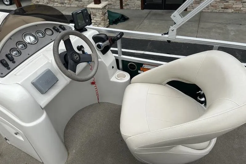 Slide: The Image of Steering console of a 2011 South Bay 420 CR boat with white captain's chair. - 15
