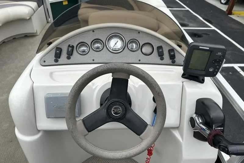 Slide: The Image of Steering console of 2011 South Bay 420 CR boat with gauges and controls. - 16