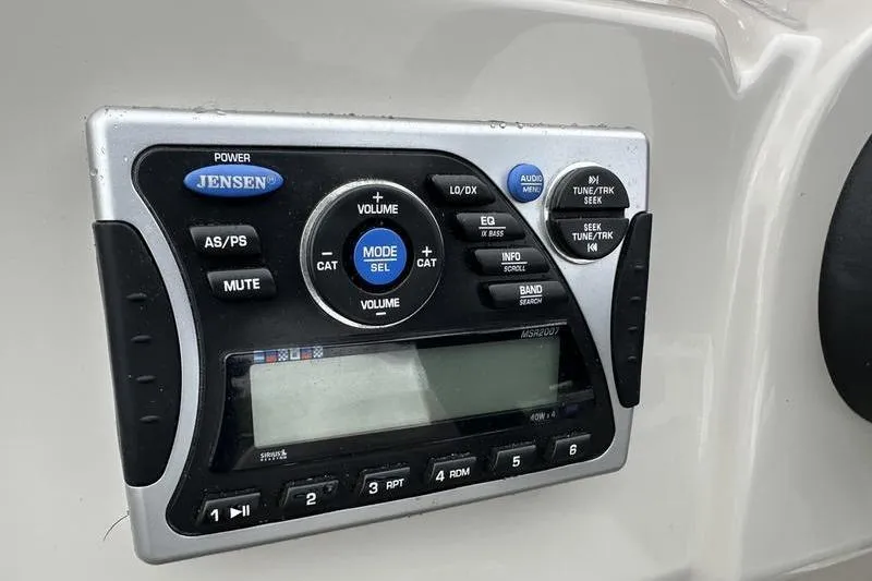 Slide: The Image of Jensen audio system on 2011 South Bay 420 CR boat dashboard. - 18
