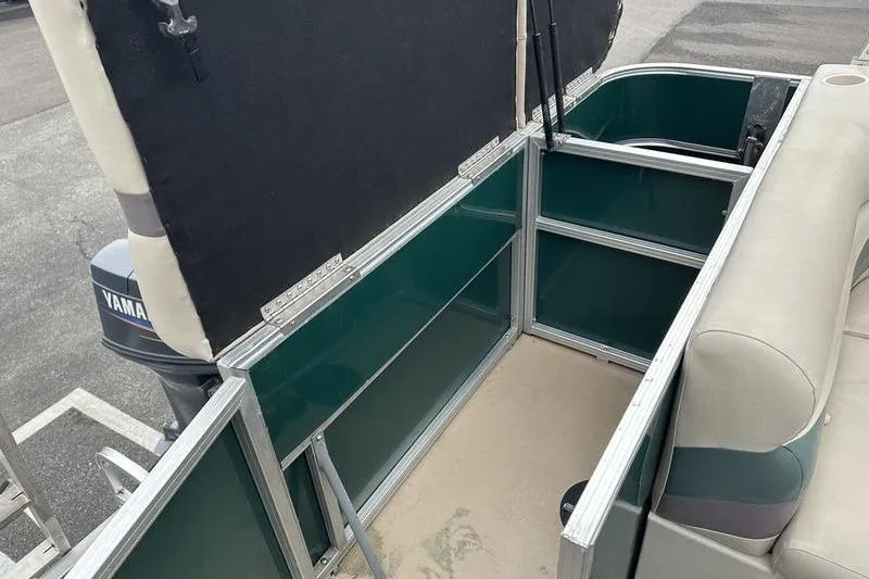 Slide: The Image of 2011 South Bay 420 CR boat interior storage compartment with Yamaha motor visible. - 21