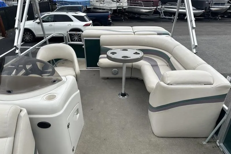 Slide: The Image of 2011 South Bay 420 CR pontoon boat interior with seating and table. - 6