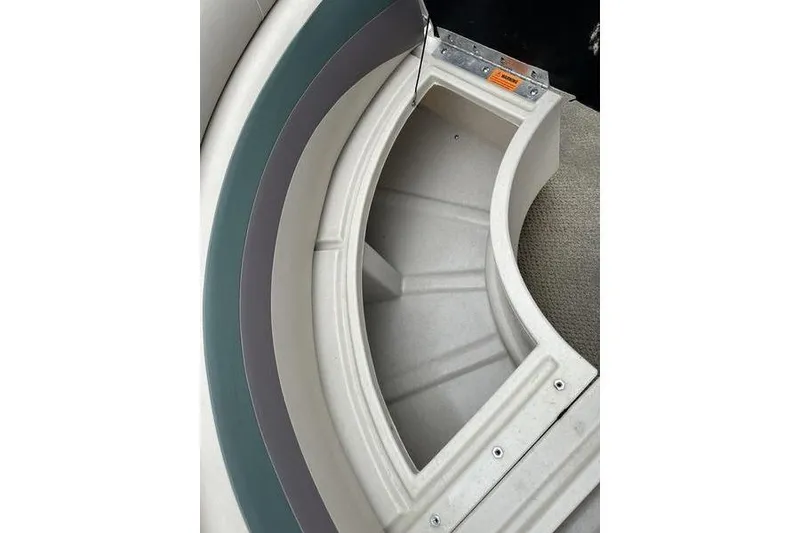 Slide: The Image of Storage compartment in 2011 South Bay 420 CR boat, featuring curved seating and carpeted flooring. - 7