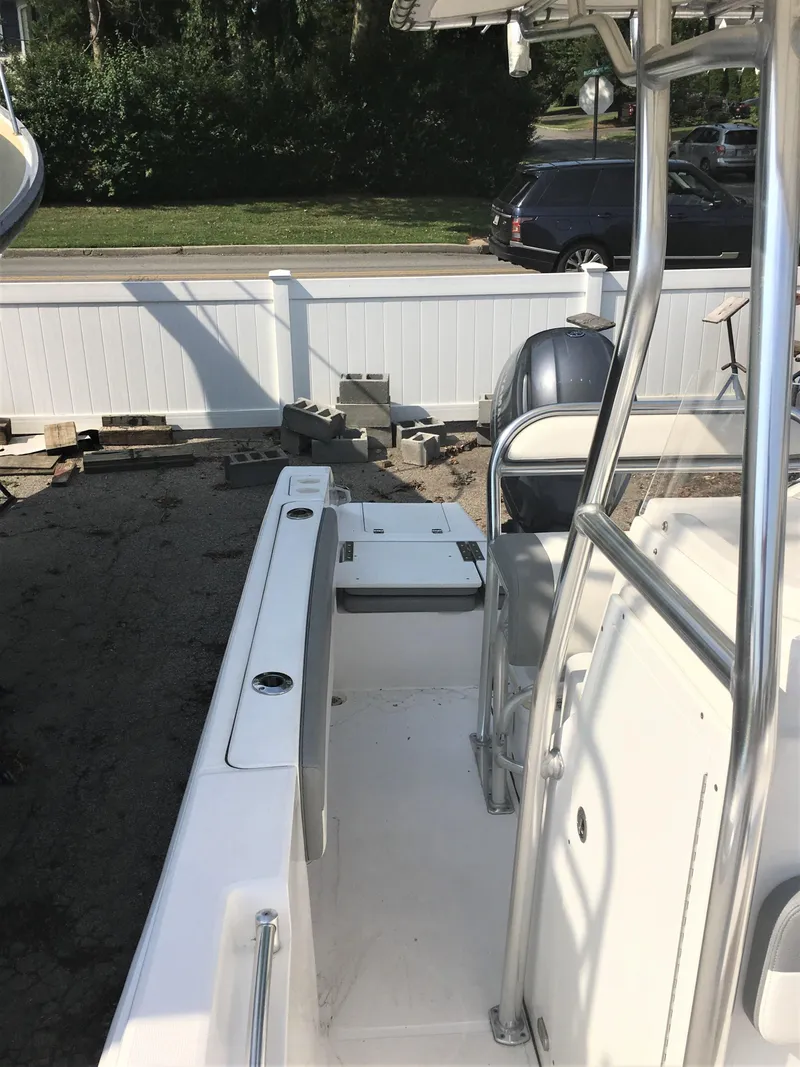 Slide: The Image of 2016 Release 208 RX boat parked outdoors, side view. - 12