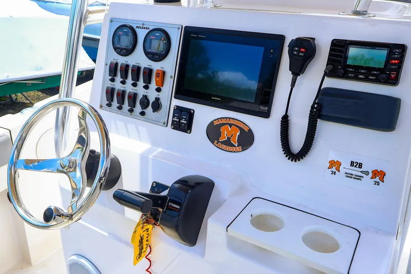 Slide: The Image of Boat dashboard of 2016 Release 208 RX with steering wheel and control panel. - 14