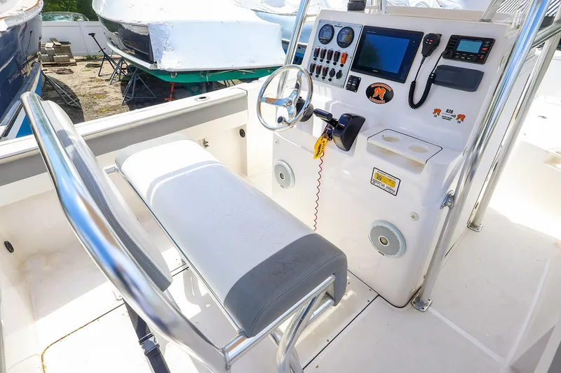 Slide: The Image of 2016 Release 208 RX boat console with steering wheel, controls, and navigation equipment. - 15