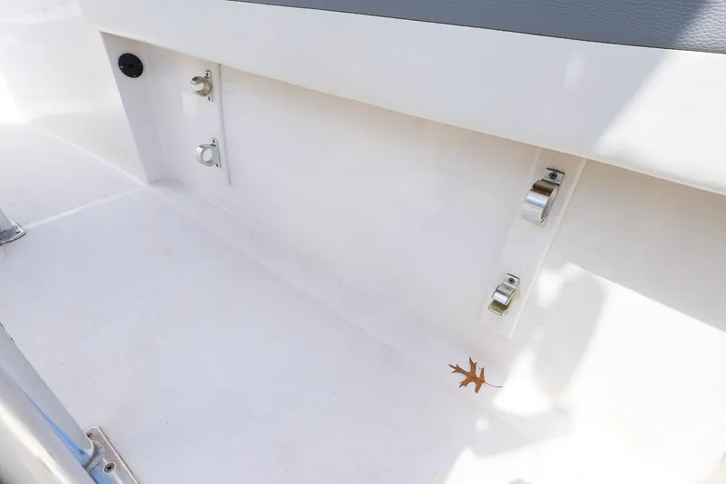 Slide: The Image of Interior view of a 2016 Release 208 RX boat, featuring clean white surfaces and metal fixtures. - 16