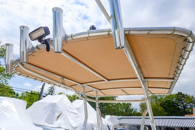 Slide: The Image of T-top of a 2016 Release 208 RX boat with rod holders and mounted light. - 19