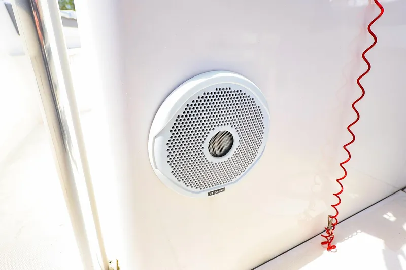 Slide: The Image of White speaker on a 2016 Release 208 RX boat with red coiled cord. - 20