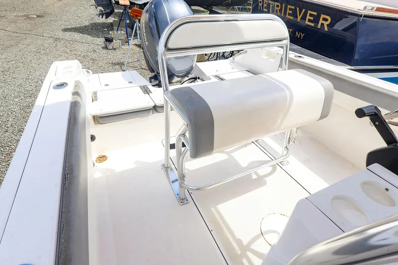 Slide: The Image of Interior of a 2016 Release 208 RX boat with seating and motor. - 21