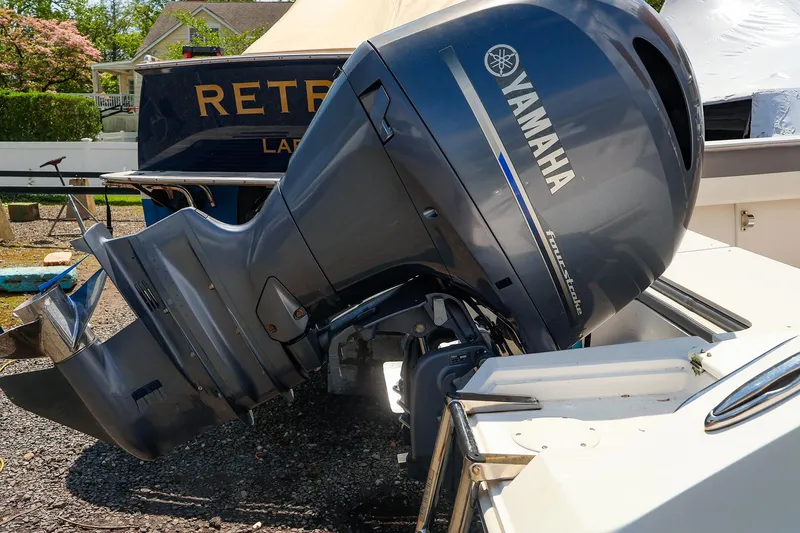 Slide: The Image of Yamaha outboard motor on a 2016 Release 208 RX boat, parked outdoors. - 25