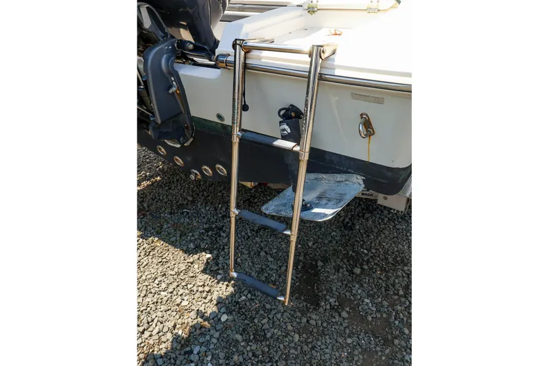 Slide: The Image of Stainless steel ladder on 2016 Release 208 RX boat, resting on gravel. - 26
