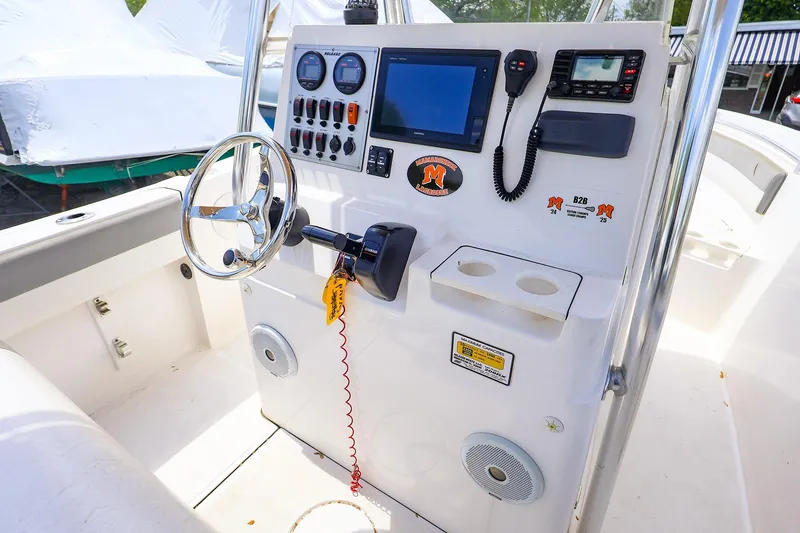 Slide: The Image of 2016 Release 208 RX boat console with steering wheel, gauges, and navigation equipment. - 28