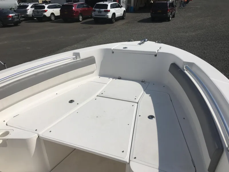 Slide: The Image of Interior view of a 2016 Release 208 RX boat on a parking lot. - 4